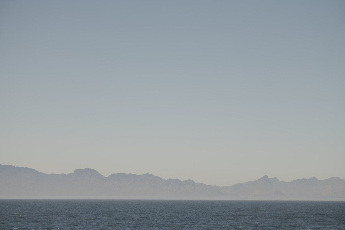 Hazy mountains across a calm sea