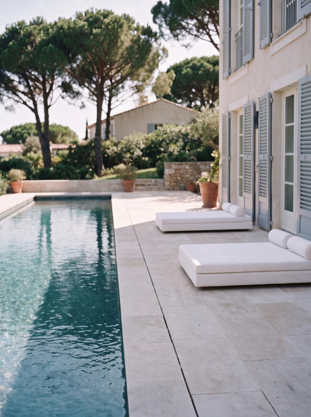 The villa pool, loungers set back