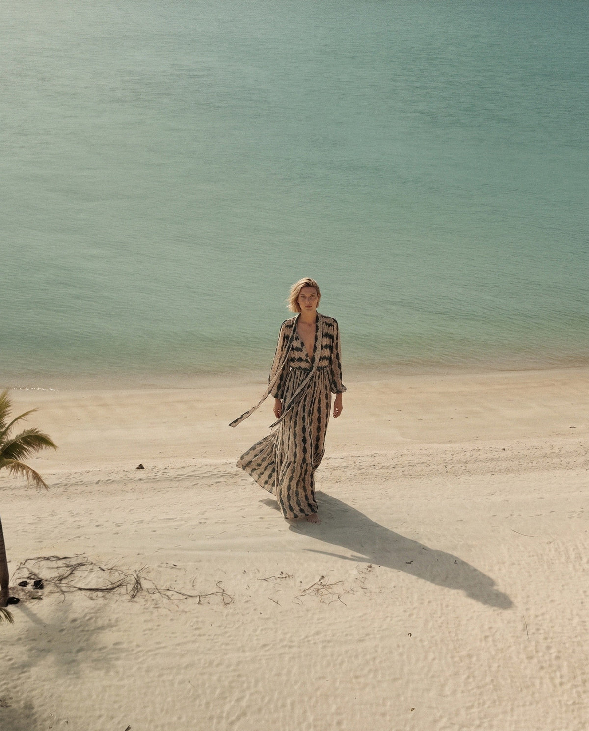 The Theo dress in Lazzar, walking on the beach